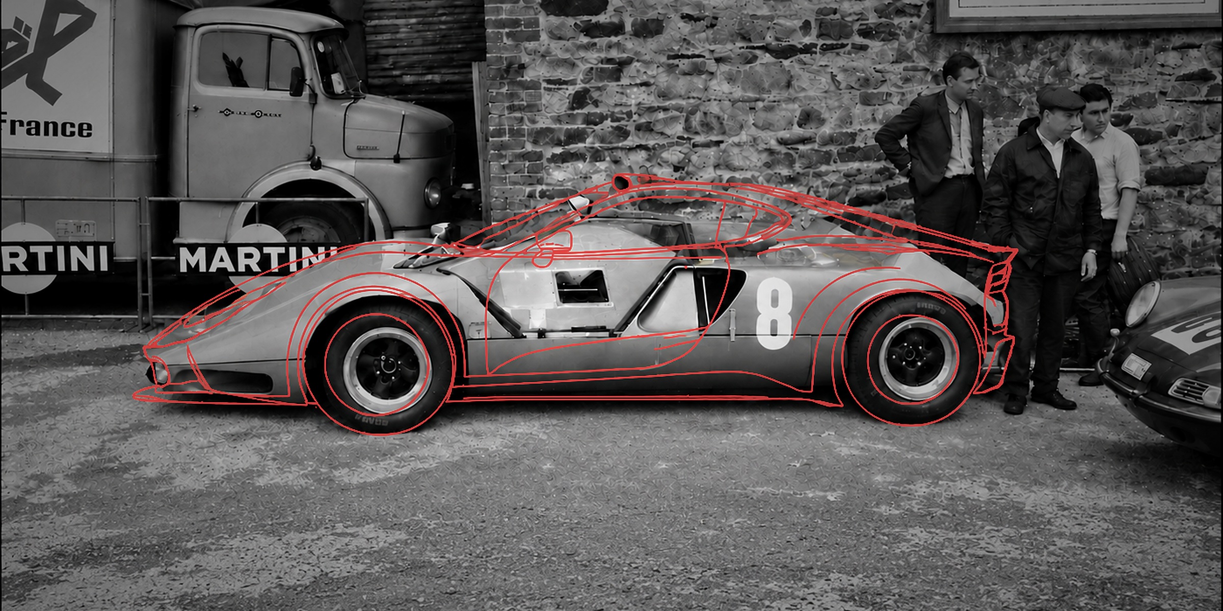 The 1968 Marcos Mantis XP in the paddock at Spa, with a red outline drawing of the 2026 Marcos Manticore superimposed on the car — the marque's past and future in one frame
